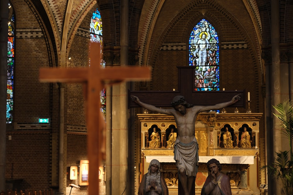 a statue of jesus on the cross in a church