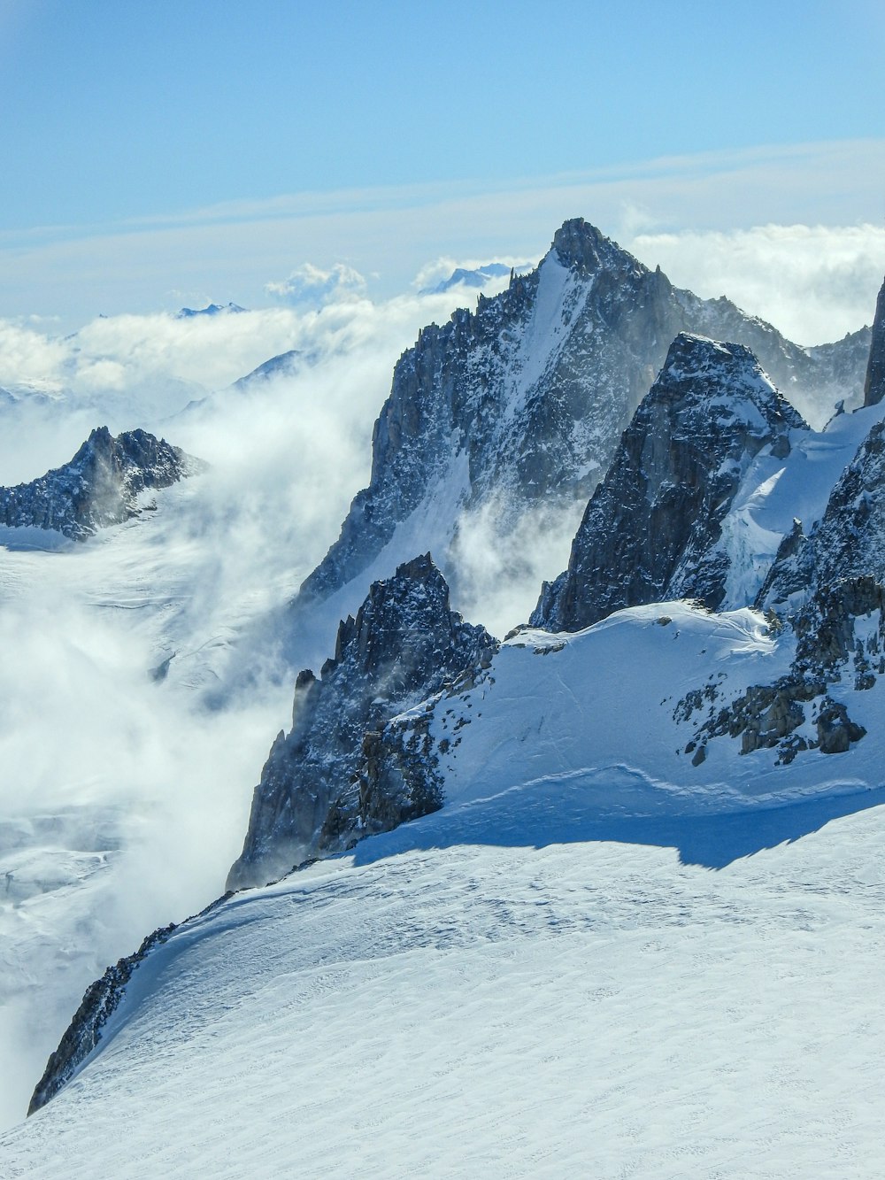 a man riding skis on top of a snow covered slope