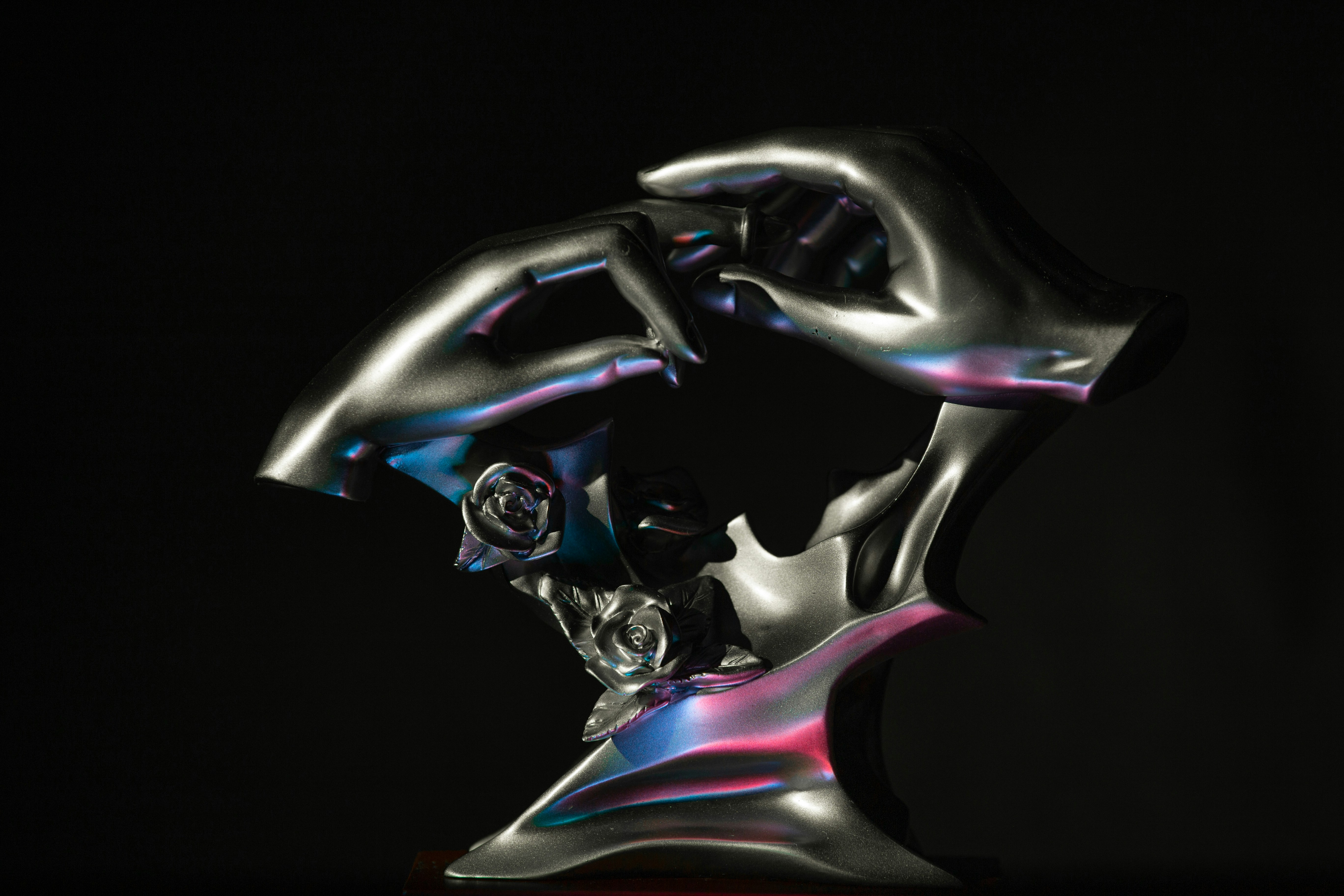 a sculpture of a human head on a black background