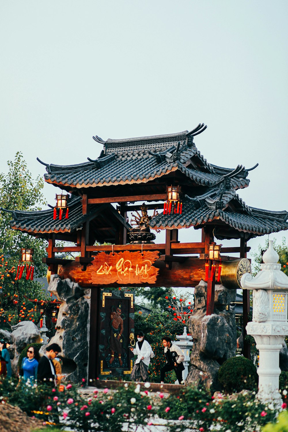 a chinese building with a lot of flowers around it