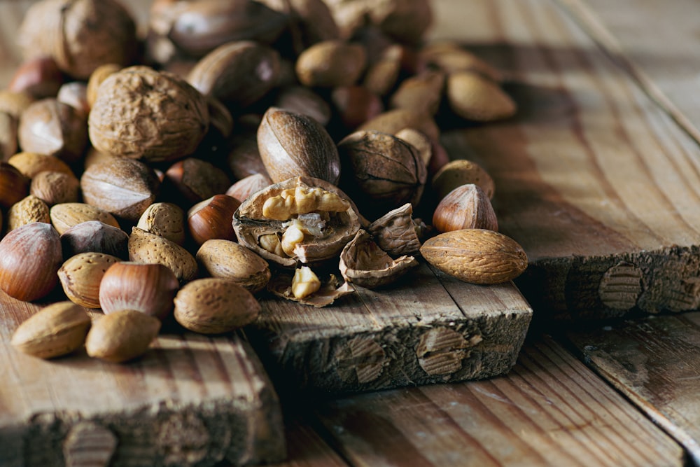 a pile of nuts sitting on top of a wooden cutting board