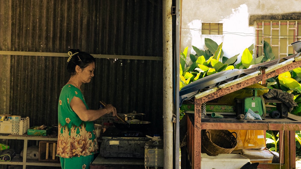 a woman standing in front of a banana tree