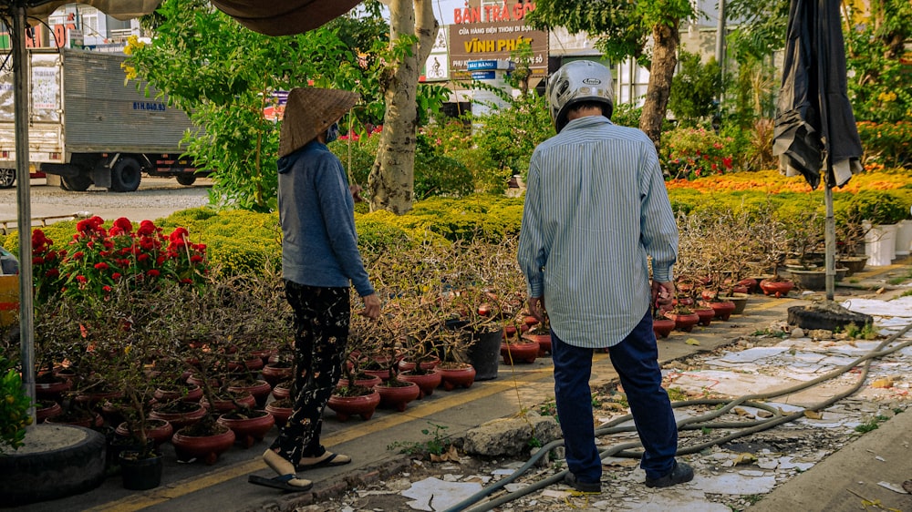 a man standing next to a woman in a garden