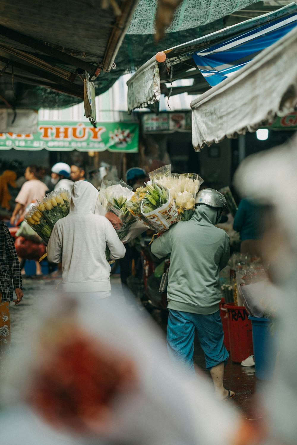 a group of people walking through a market