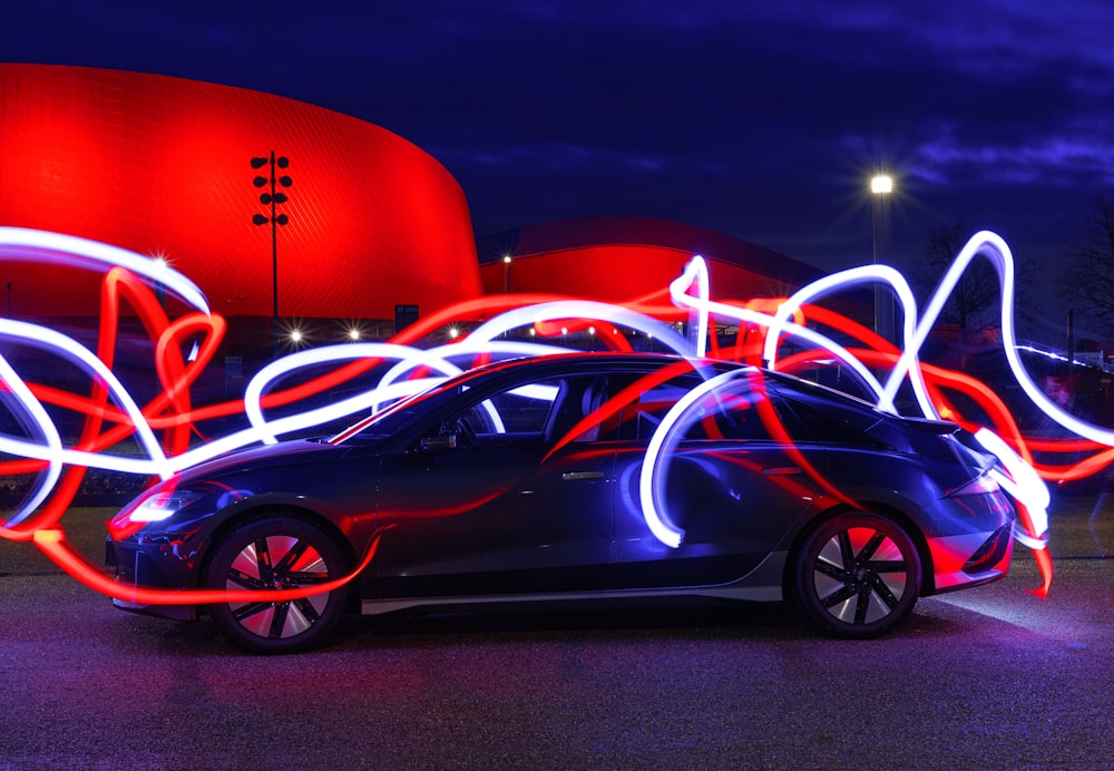 a car parked in front of a red building