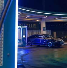 a blue car is parked at a gas station