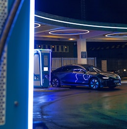 a blue car is parked at a gas station