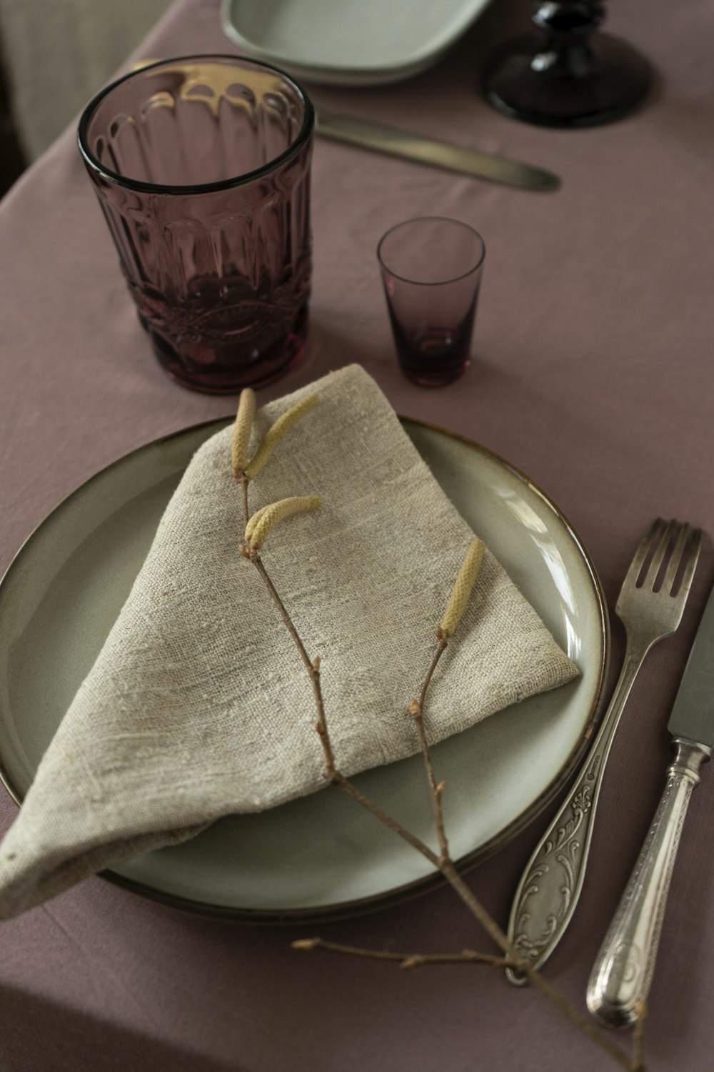 a place setting with a napkin, fork and knife
