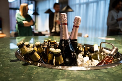 a metal tray filled with bottles of champagne