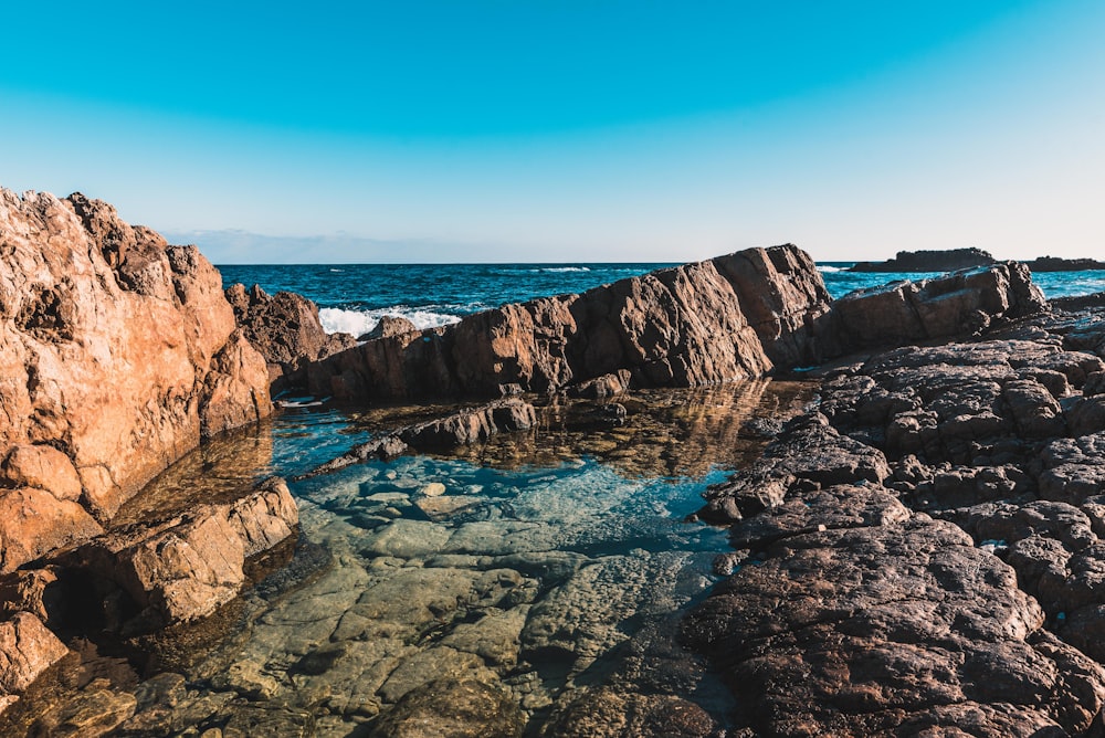 a body of water surrounded by large rocks