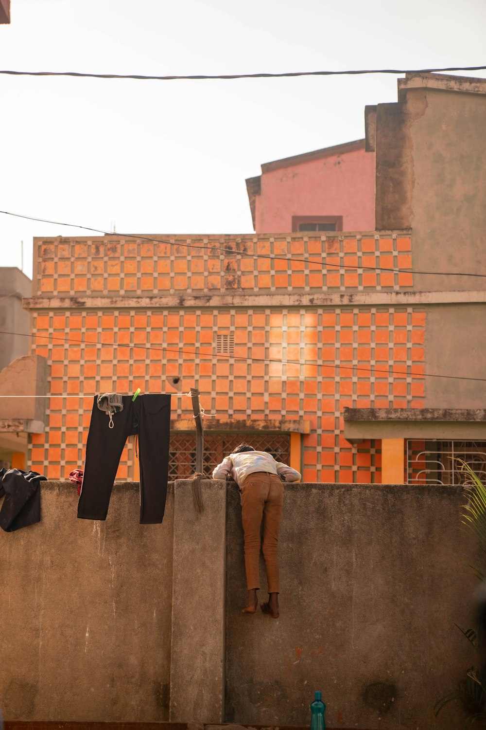 a man is hanging out on a wall