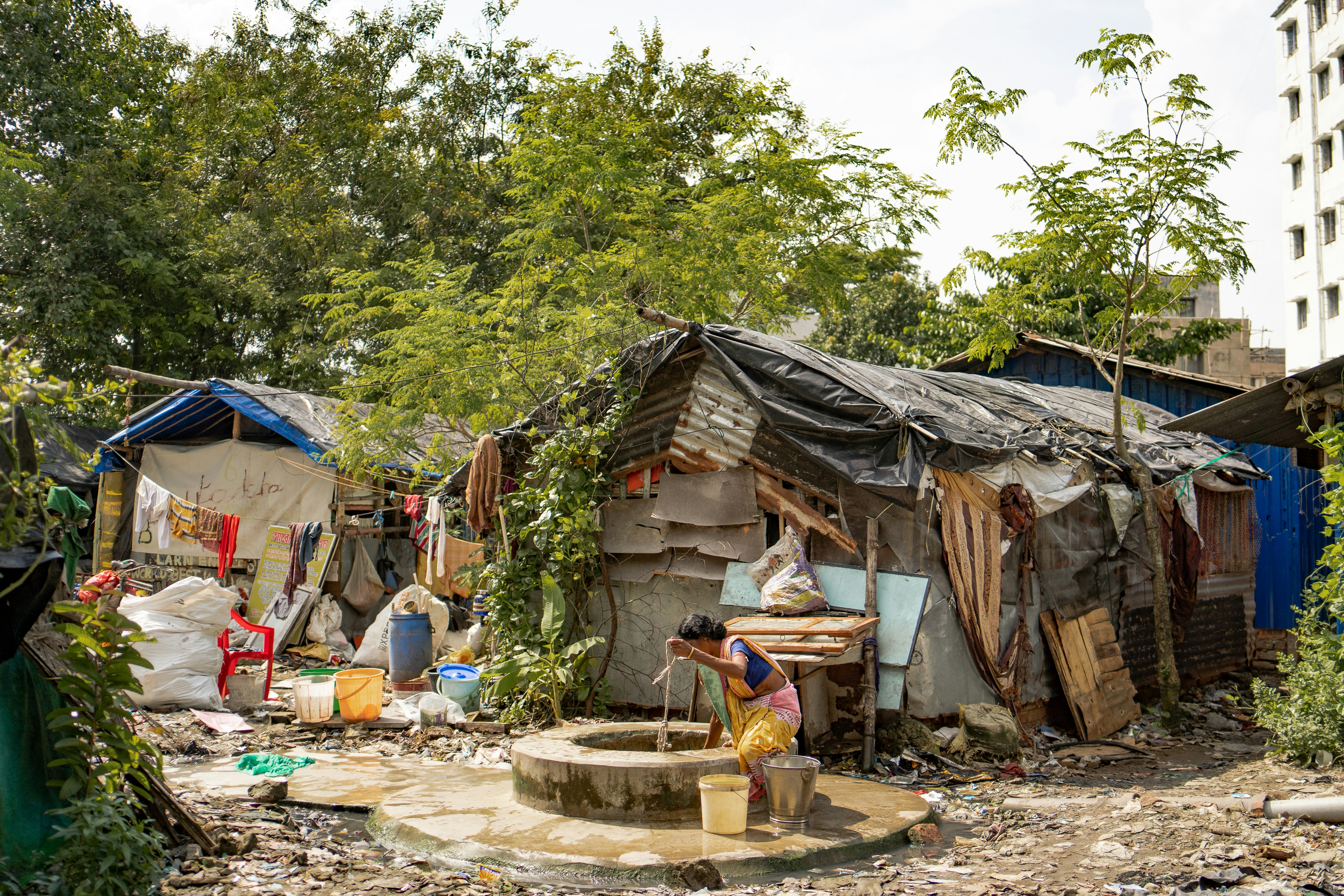 a group of people standing outside of a shack