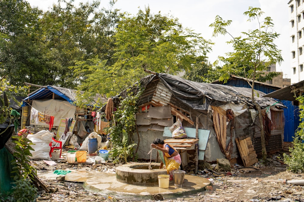 a group of people standing outside of a shack