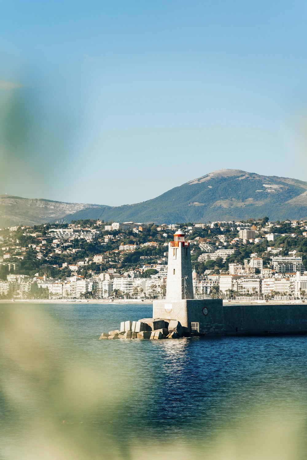 a light house sitting in the middle of a body of water