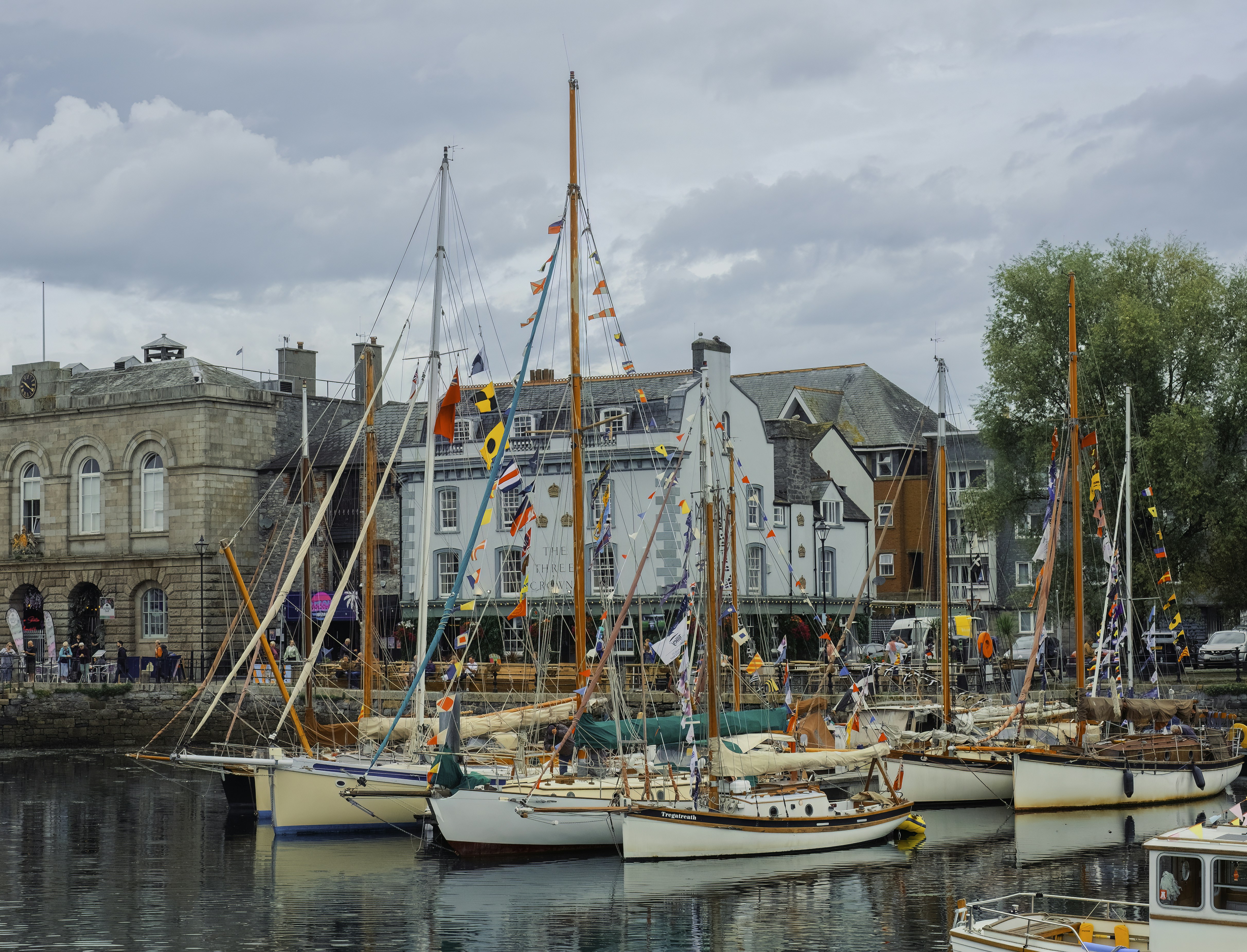 a harbor filled with lots of boats next to tall buildings