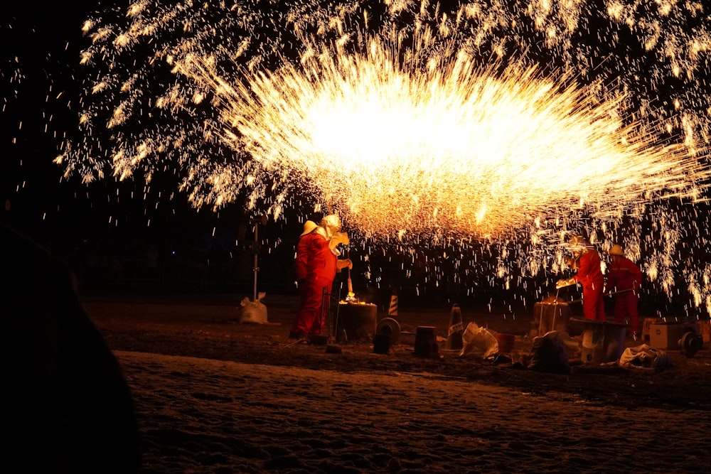 a group of people standing around a firework display