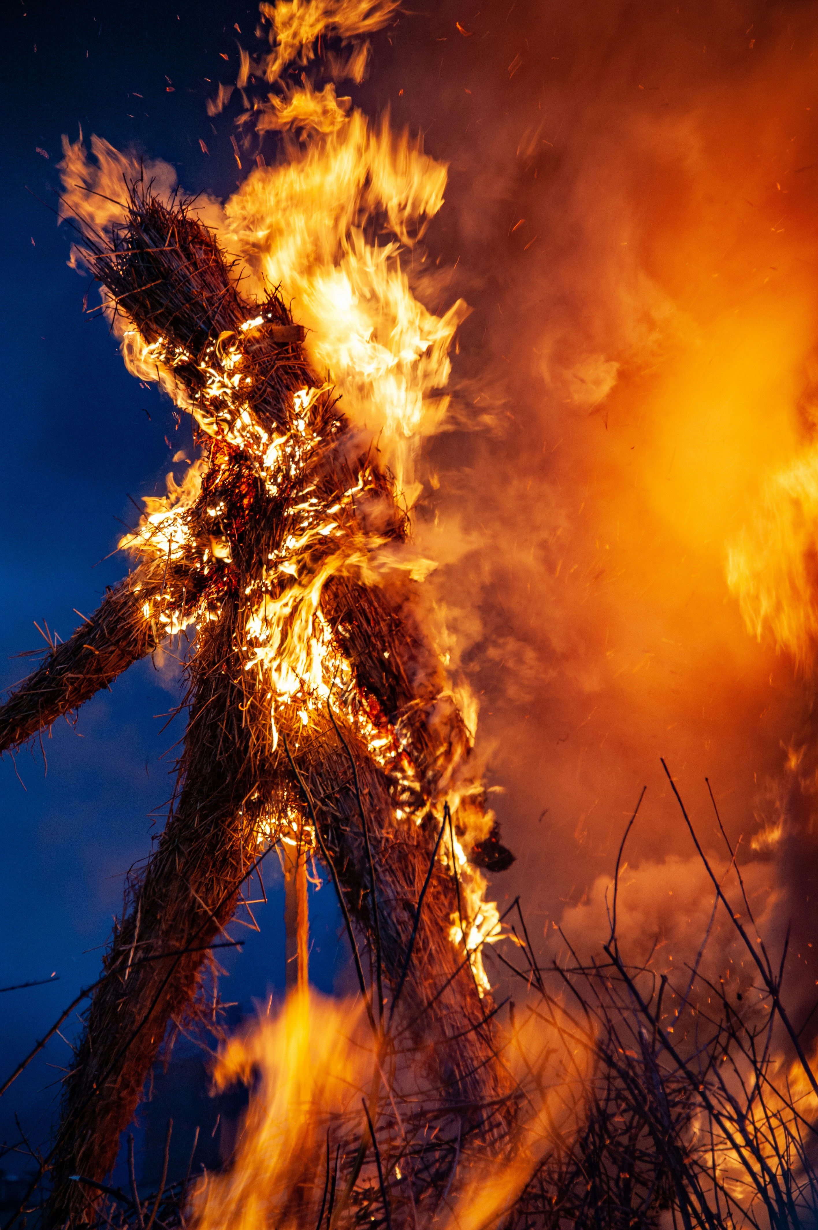a fire is burning in a field at night