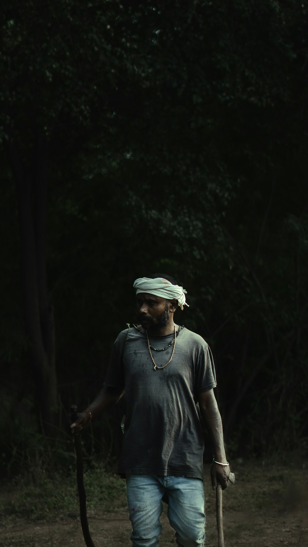 a man walking with a stick in his hand