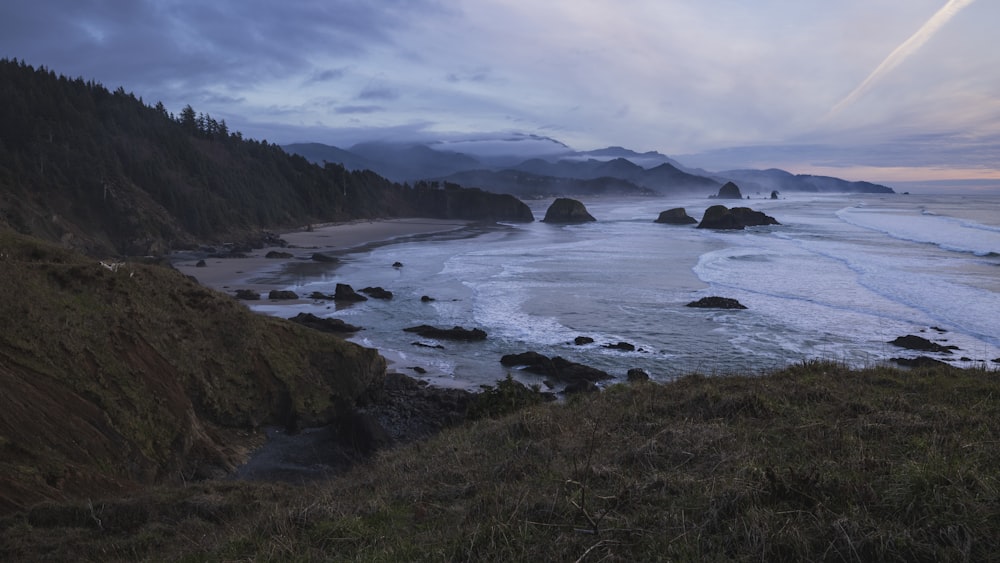 a view of a beach with mountains in the background