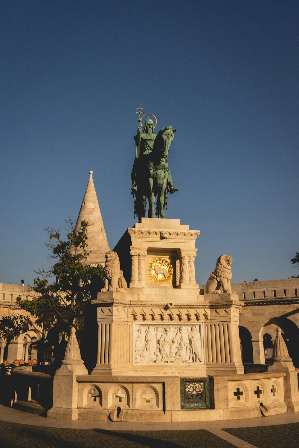 a statue of a man on a horse in front of a building