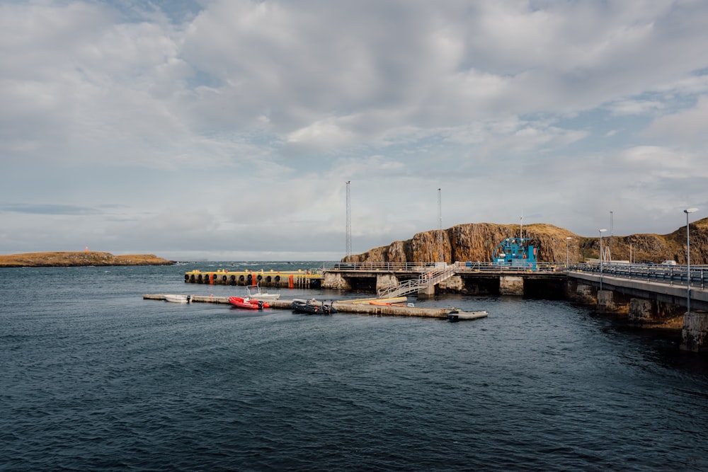 a long dock with a boat in the water