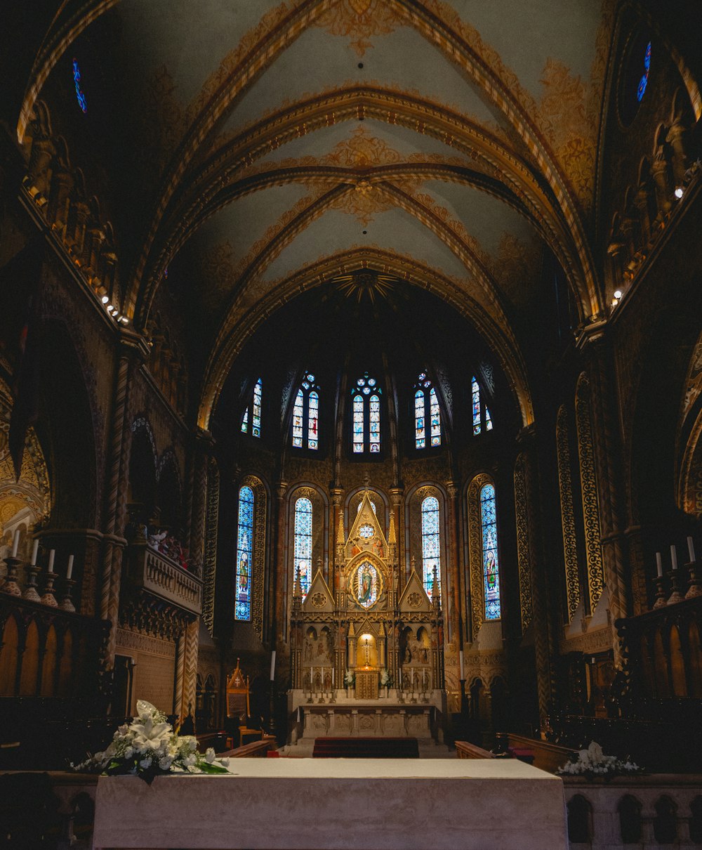 a church with a high altar and stained glass windows