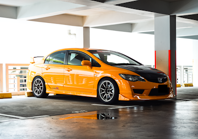 a yellow car parked in a parking garage