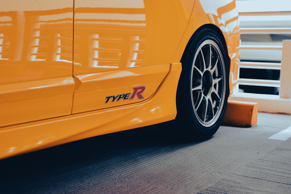 a close up of a yellow sports car