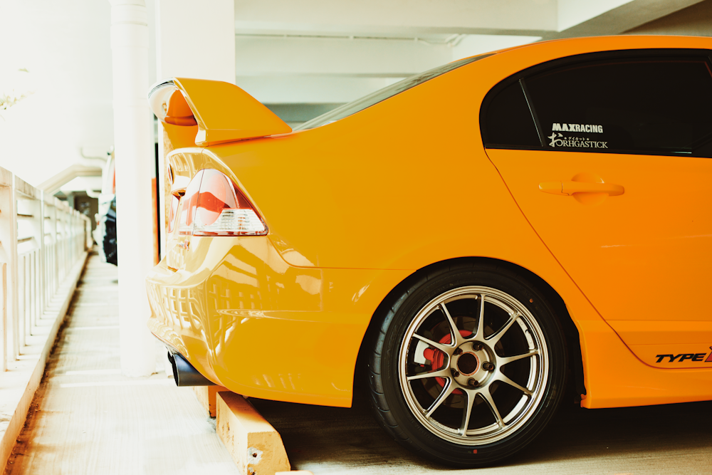 a yellow car parked in a parking garage