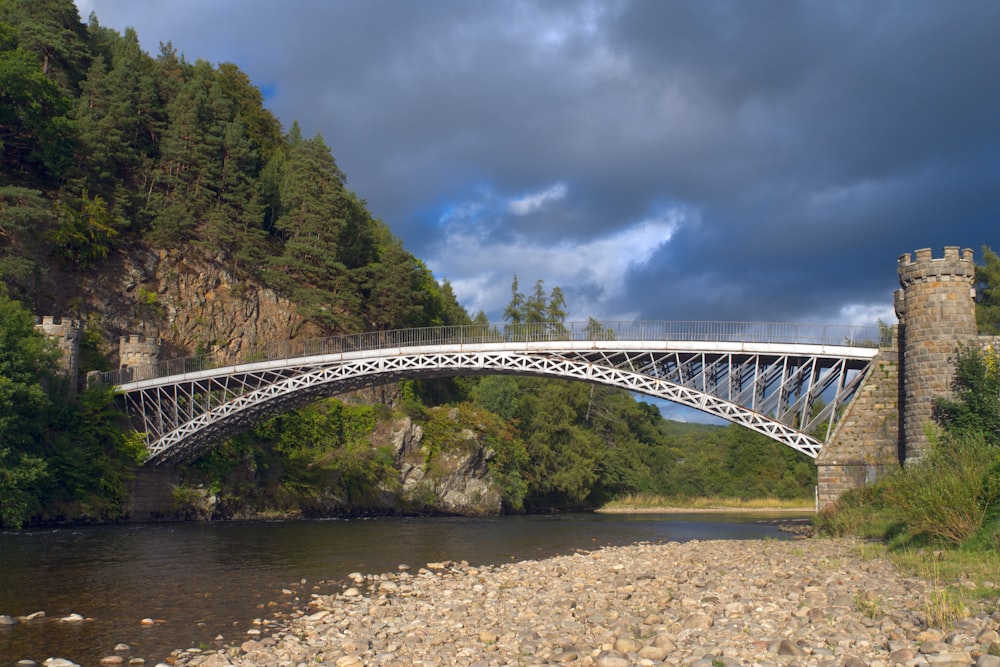 a bridge over a river with a castle in the background