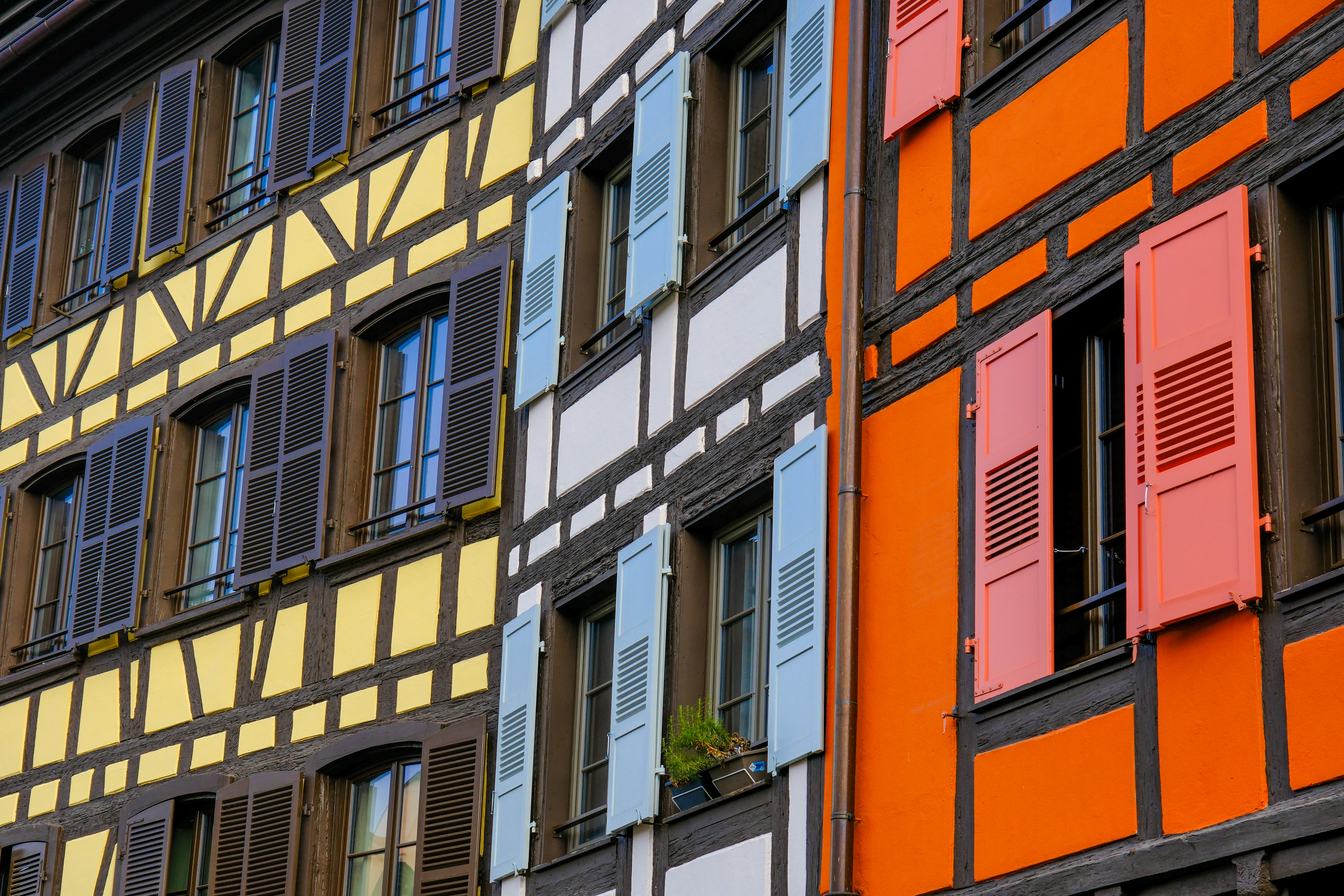 a multicolored building with shutters and windows