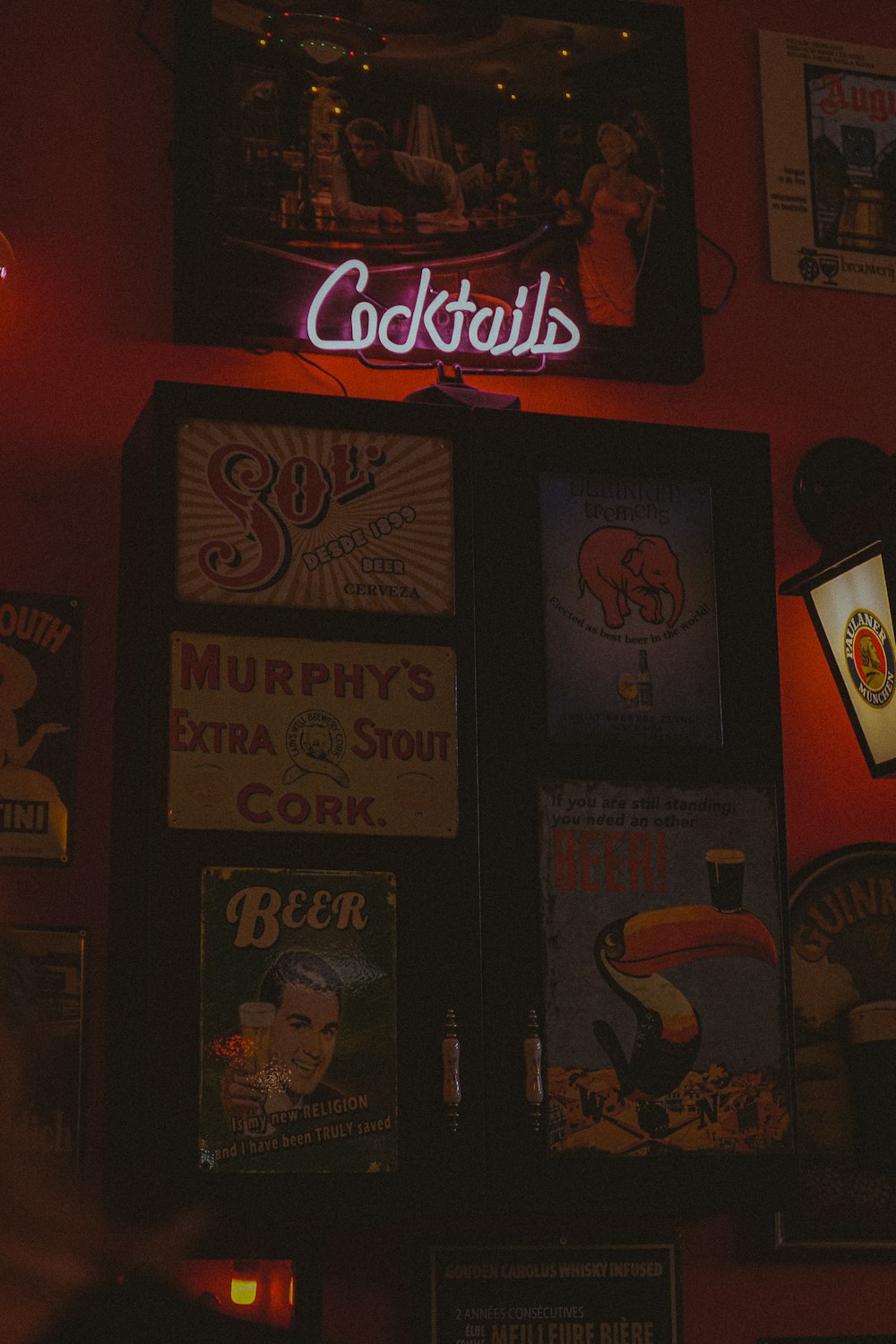 a red wall with a neon sign above it