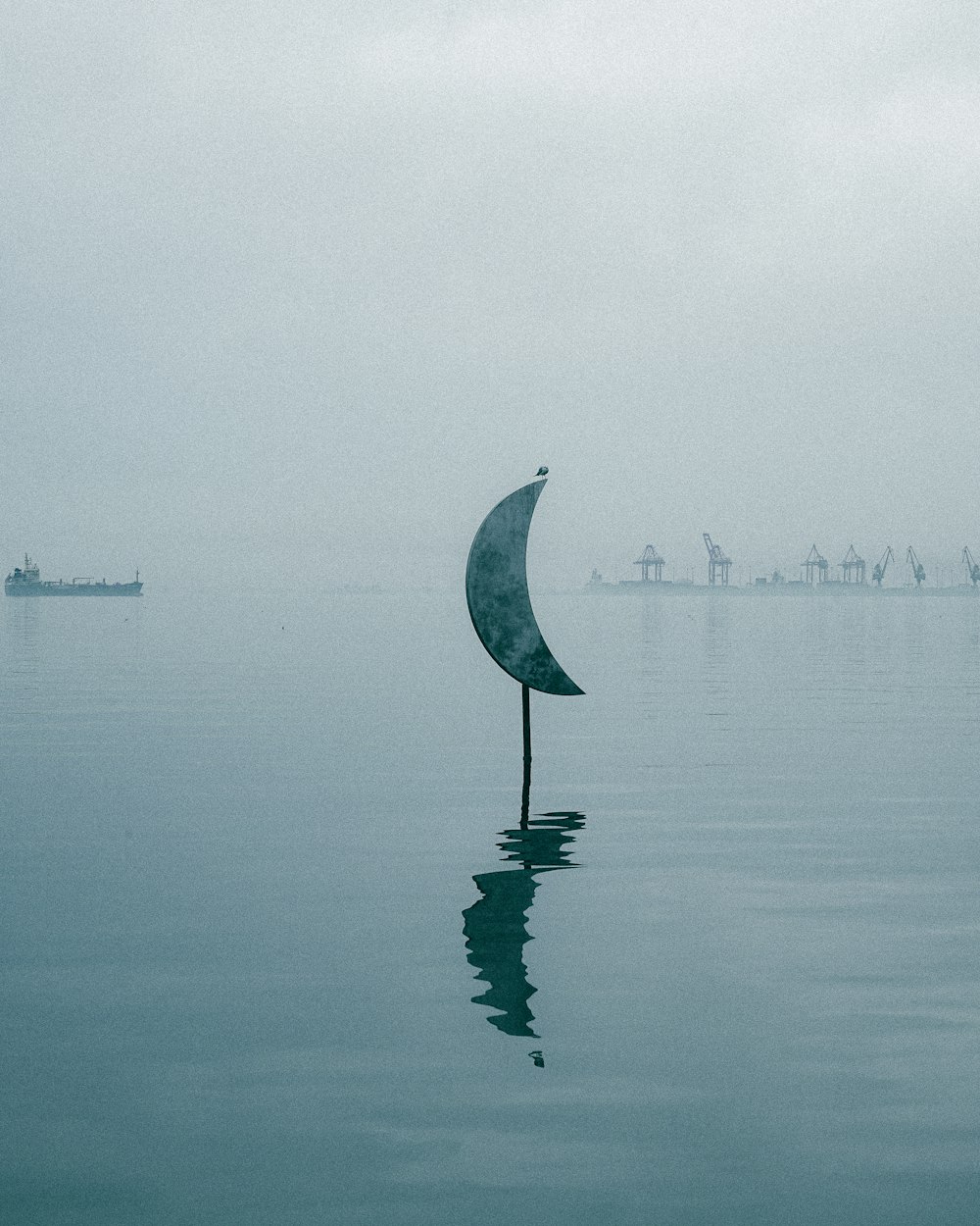 a sail boat floating on top of a body of water