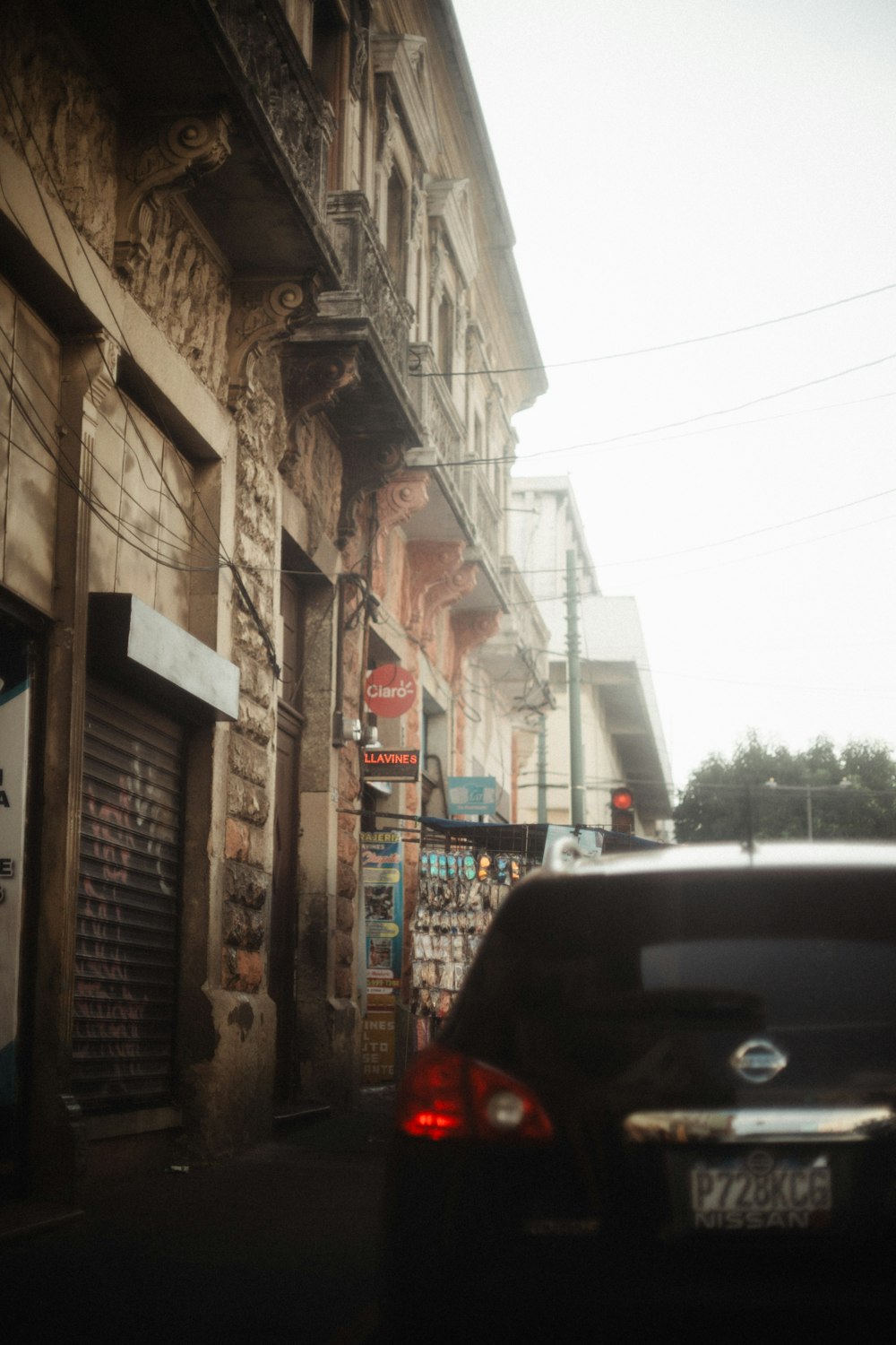 a car parked on the side of a street next to a building