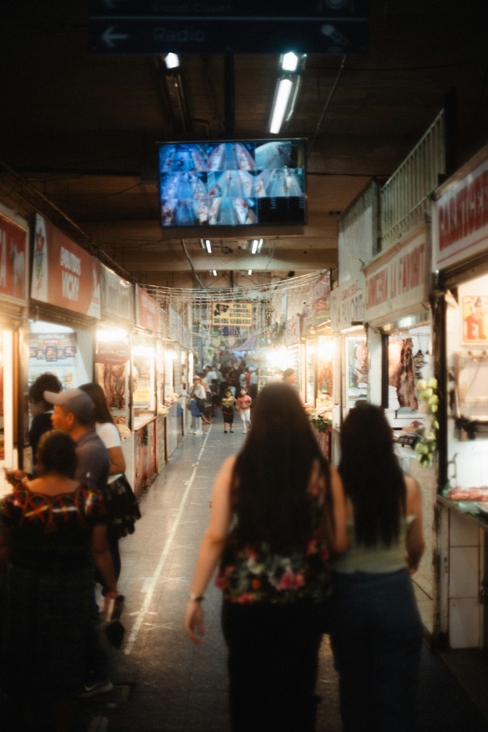 a group of people walking down a long hallway