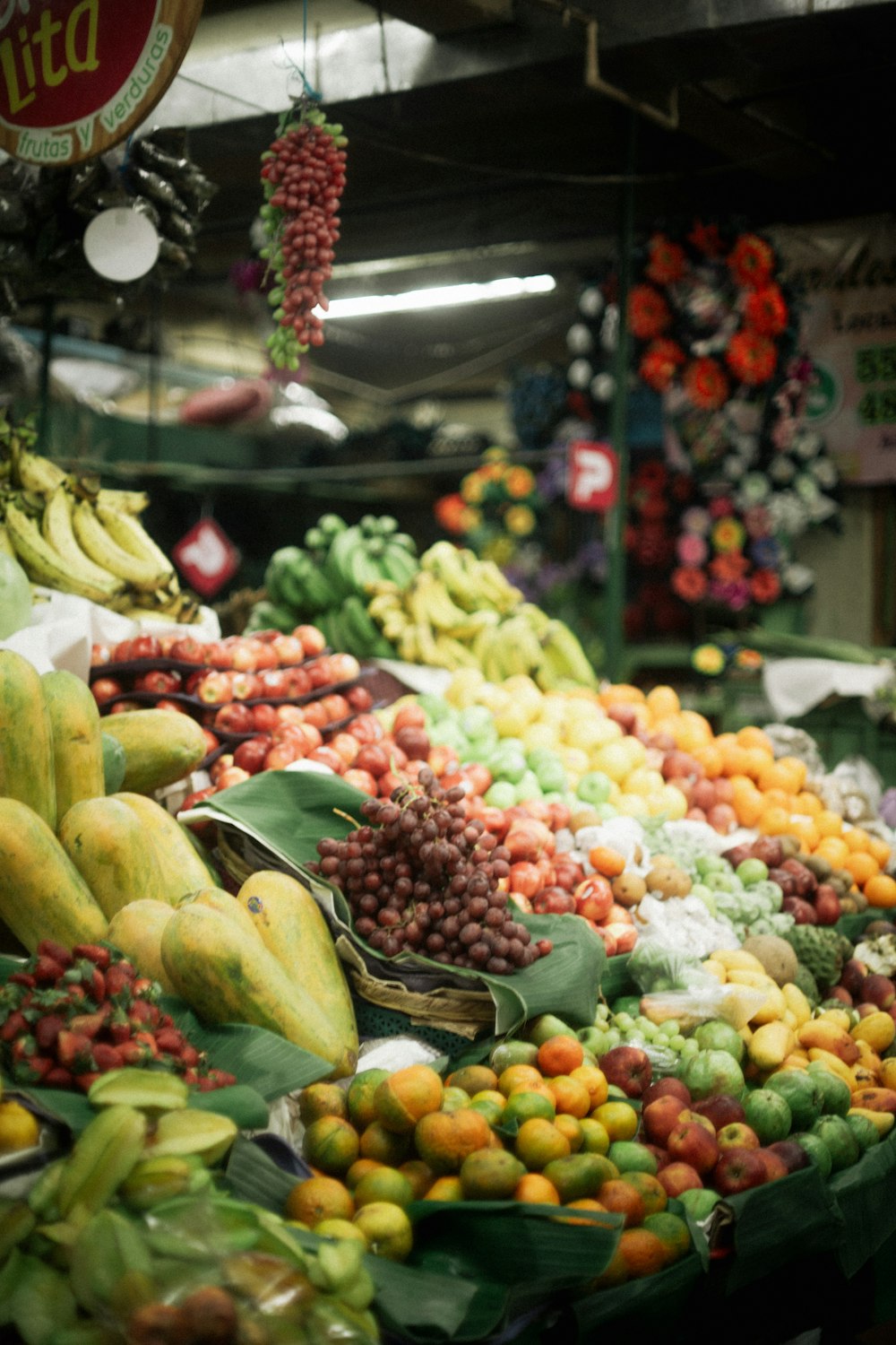 a large display of fruits and vegetables in a store