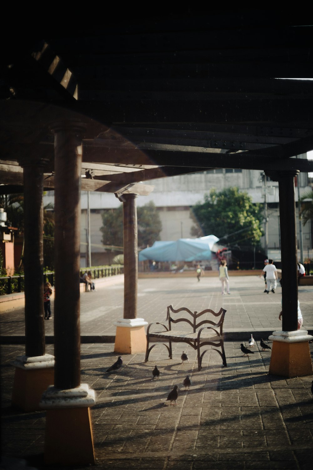 a wooden bench sitting on top of a sidewalk