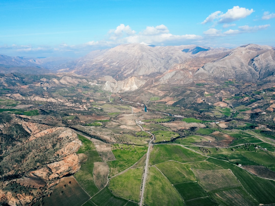 an aerial view of a valley and mountains,