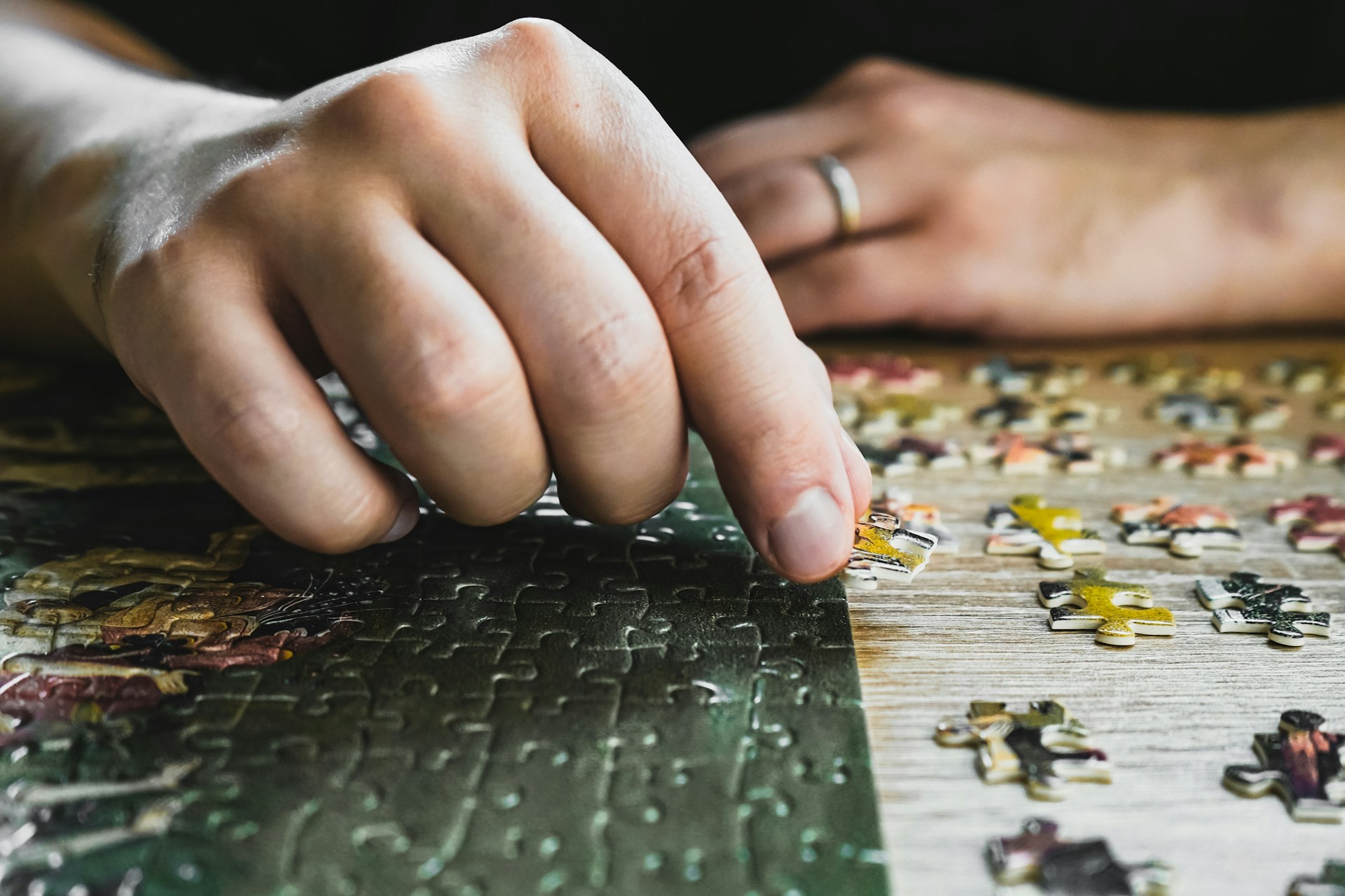 a close up of a person's hand on a puzzle
