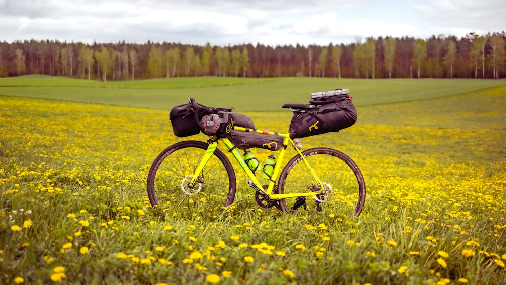 a yellow bike parked in a field of yellow flowers