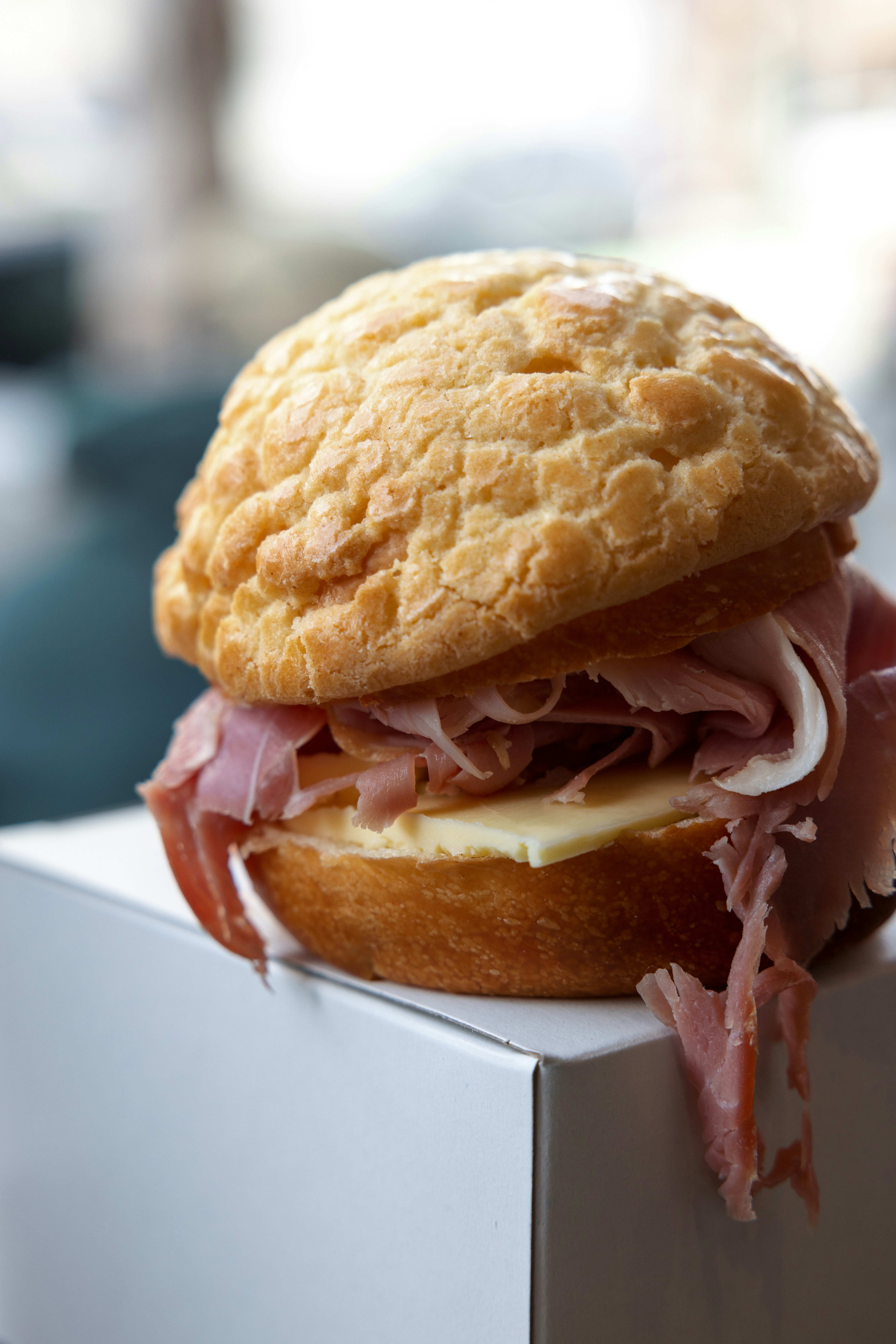 a sandwich sitting on top of a white box