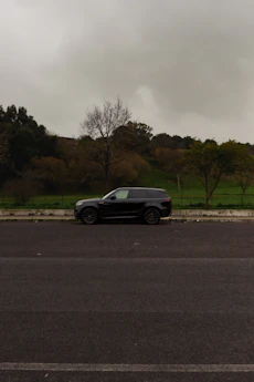 a black car parked on the side of the road