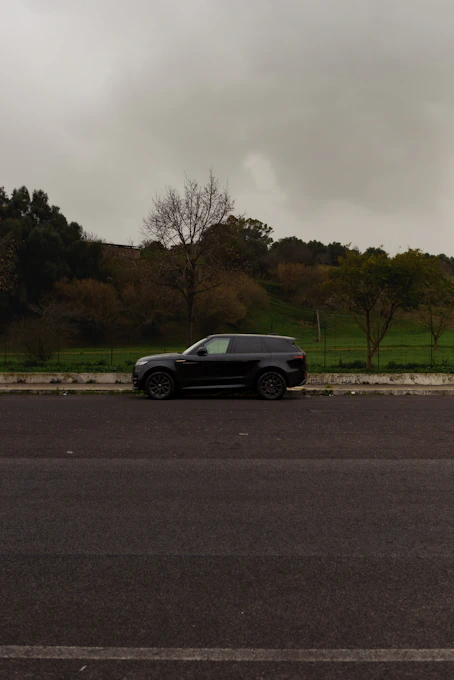 a black car parked on the side of the road