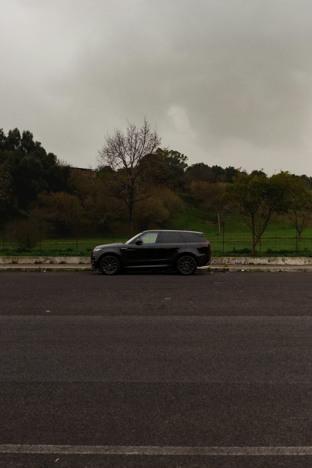 a black car parked on the side of the road