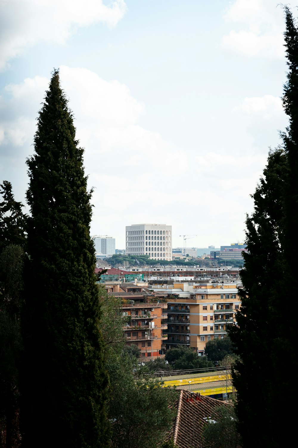 a view of a city through some trees