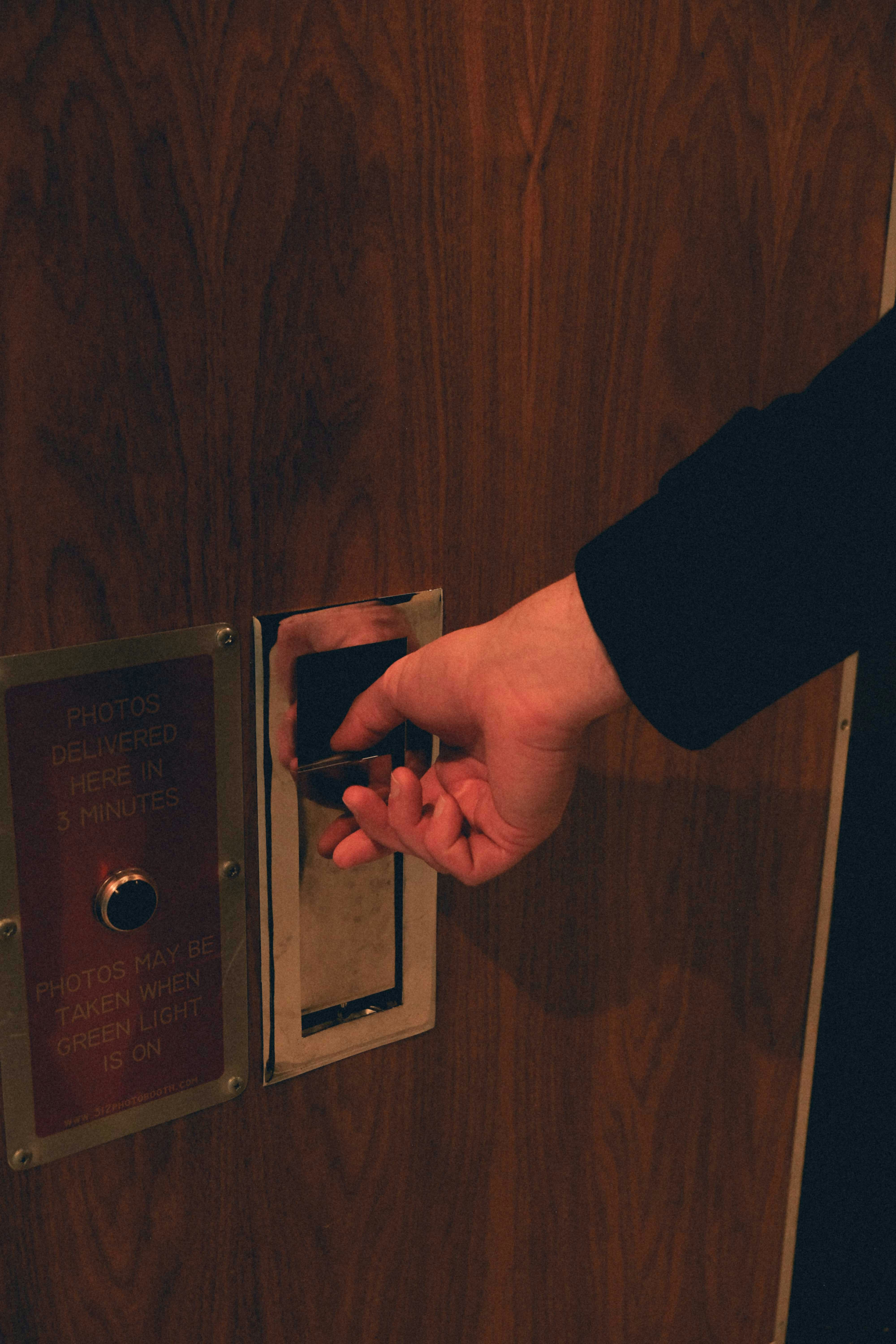 a person opening a door with their hand