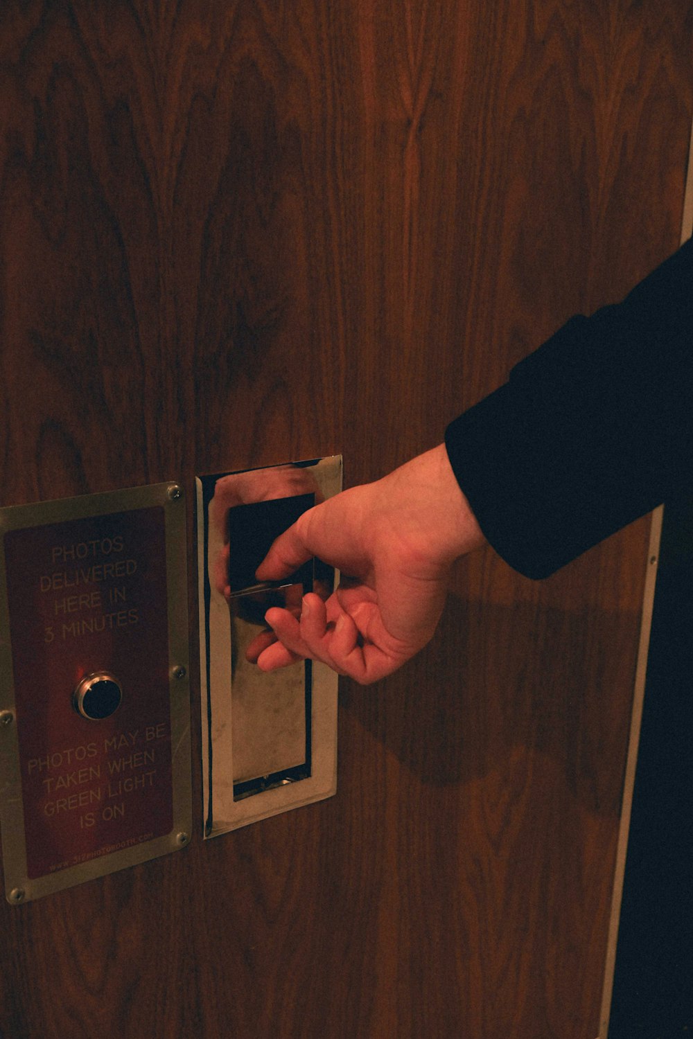 a person opening a door with their hand