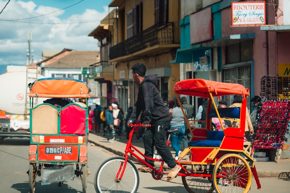 a man riding a cart pulled by a horse down a street