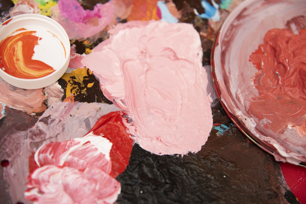 a bowl of paint sitting on top of a table