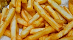 a pile of french fries sitting on top of a table